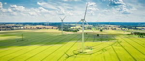 wind-turbines-on-golden-green-field-in-summer-aer-2026-01-09-06-44-07-utc-1
